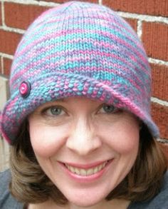 a smiling woman wearing a knitted hat