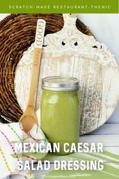 mexican ceasar salad dressing in a jar with a wooden spoon next to it