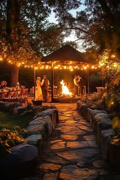 A cozy fall wedding scene with a gazebo illuminated by string lights, a bonfire, and rustic autumn garden decor creating a warm and inviting atmosphere for an outdoor wedding. Autumn Wedding Decor, Wedding Reception Activities