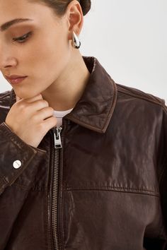 The Theia Leather Bomber is the embodiment of understated luxury with its oversized fit, shirt collar, and supple lamb leather construction. Pair it with shorts, a basic tee, and a baseball hat for a laid-back yet cool look. The Theia Leather Bomber Jacket is a versatile essential that will elevate any outfit. Modern Oversized Leather Jacket, Classic Oversized Leather Jacket, Casual Everyday Leather Jacket, Drop Shoulder Shirt, Understated Luxury, Basic Tee, Baseball Hat, Shirt Collar, Snug Fit