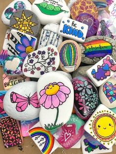 many rocks have been painted with different designs and colors, including the words i love you