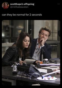 a man and woman sitting at a table looking at something on the computer screen with caption that reads, can they be normal for 2 seconds?