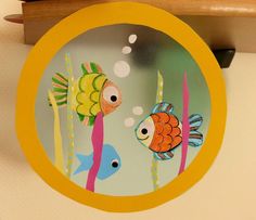 an image of two fish in the water on a glass plate that is hanging from a shelf