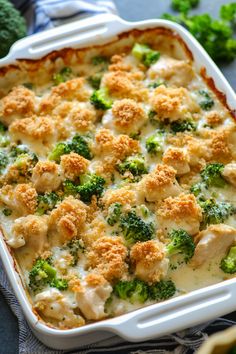 a casserole dish with chicken and broccoli in it on a table