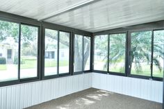 an empty room with large windows in it