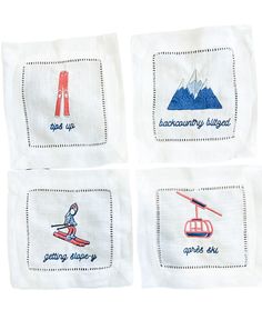 four napkins with embroidered images of skiers and ski lifts on them, each featuring the same mountain