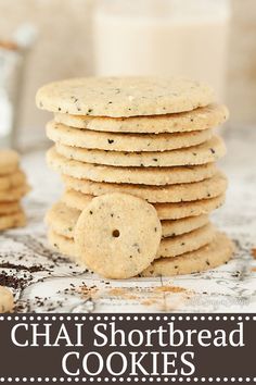 a stack of chai shortbread cookies next to a glass of milk