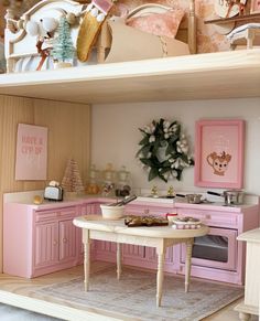 a doll house kitchen with pink furniture and accessories