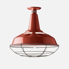 a red light hanging from the ceiling with an overhanging fixture in front of a white background