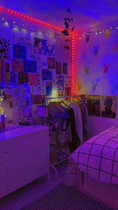 a bedroom decorated in purple and blue lights