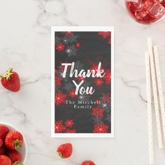 thank you card with red snowflakes and strawberries on the table next to it