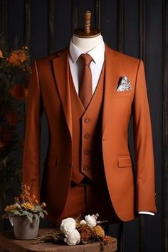 an orange suit and tie sitting on top of a wooden table