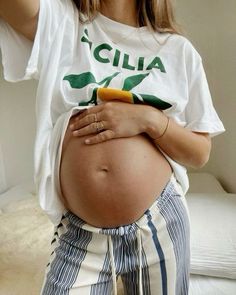 a pregnant woman taking a selfie with her cell phone