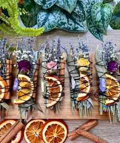 an arrangement of dried oranges and herbs on a cutting board next to some cut up grapefruit slices