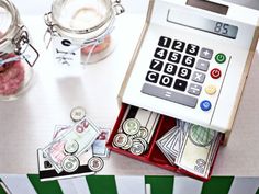 a calculator sitting on top of a table next to some jars and money