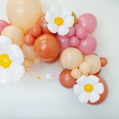 some balloons and flowers on a white table