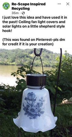 a bell hanging from a metal pole in front of some trees and water with the caption saying it was found on pinterest - plas