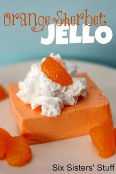 an orange sherbet jello dessert with whipped cream and candies on top