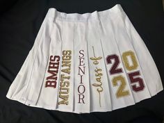 PLEASE READ Calling all Graduates of any Class! Celebrate your special day in style with our Custom Graduation Skirt! Perfect for making a memorable statement on your graduation day, this skirt is designed to be both elegant and comfortable.  This outfit can be designed with any color of your choice, it does not have to be your traditional school colors! Production time is 2-3 WEEKS so please order in a timely manner. If you need it before 3 WEEKS, a "Rush Order Fee" is REQUIRED & does NOT include shipping.  Please contact me before placing your order so I can let you know if I can get it to you on time. *NO REFUNDS ON PERSONALIZED ITEMS* If there is a problem with your order please reach out to me. White Mini Skirt For Cheerleading, White Pleated Skort For Cheerleading, White Pleated Skirt Skort For Cheerleading, Fitted White Skirt For Cheerleading, Graduation Skirt, College Skirt, Painted Skirt, Senior Graduation, Grad Photos