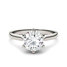 a round brilliant cut diamond engagement ring in 18k white gold, set with a claw - prong band