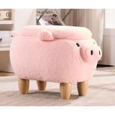 a pink pig foot stool with wooden legs