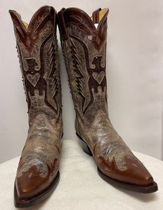 Elevate your Western style with these stunning Corral Boots. The brown leather  is adorned with a beautiful sequin eagle inlay, adding a touch of glamour to the classic Western design. The boots feature a comfortable 8.5 US shoe size, 8 1/2 EU shoe size, and a sturdy boot heel.  Perfect for any occasion, these boots are a must-have for any fashion-forward woman. The brown color and eagle theme make them an ideal addition to your boots collection. Step out in style with these Corral Boots and mak Embellished Leather Boots With Snip Toe, Western Leather Embellished Boots, Western Style Embellished Leather Boots, Embellished Brown Round Toe Boots, Brown Embellished Round Toe Boots, Embellished Brown Leather Boots, Brown Leather Embellished Boots, Designer Brown Snip Toe Boots, Corral Boots