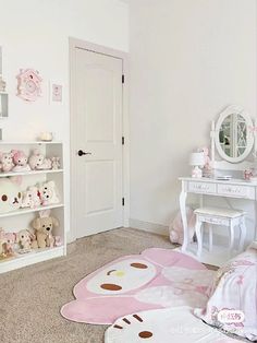 a white room with teddy bears on the floor and pink rugs in front of it