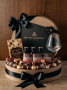 a wine glass and chocolates in a gift box