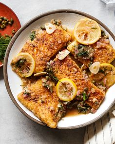 some fish with lemons and capers on a plate