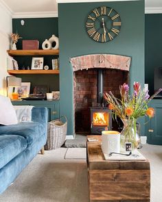 a living room with a couch, coffee table and clock on the wall above it