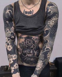 a man with tattoos on his body and chest