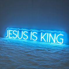 a neon sign that says jesus is king