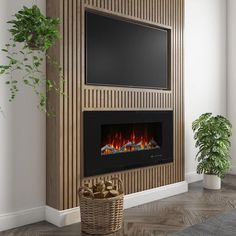 a living room with a television and fireplace in the corner, next to a potted plant