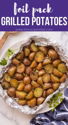 foil packet filled with grilled potatoes on a white plate