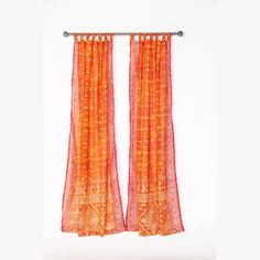 an orange curtain hanging on a white wall