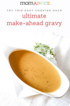 a white bowl filled with gravy on top of a table