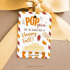 an orange and white striped gift tag with the words pop by to wish you a happy fall