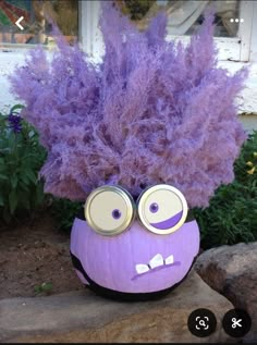 a purple plant with eyes painted on it