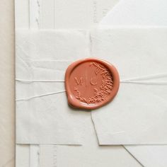 a wax stamp on top of some white envelopes