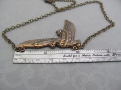 "Vintage Art Nouveau design Egyptian Revival Bird Pendant Necklace. A fabulous Horus falcon design, with a tiny sparkling rhinestone accent. Beautiful Antiqued brass. Ornate detailed bird, 2-1/8\" across. Antiqued brass finish brass chain with a lobster clasp. Sent to you with Aloha! #91 More of my Artisan Jewelry: hawaiibeads.etsy.com" Horus Falcon, Falcon Design, Steampunk Cosplay, Egyptian Revival, Art Nouveau Design, Bird Pendant, Art Deco Necklace, Star Art, Swarovski Pearls