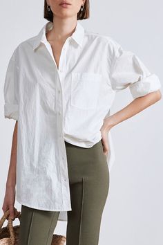 Oversized menswear-inspired shirt with classic collar, button down front, patch pockets at the chest and shirttail hem. Crafted from 100% organic cotton. Oversized Cotton Shirt In Effortless Style, Oversized Cotton Shirt With Roll-up Sleeves, Effortless Cotton Shirt For Daywear, Cream Cotton Button-up Shirt, White Cotton Shirt With Buttoned Pockets, Cream Relaxed Fit Button-up Shirt, Effortless Collared Cotton Shirt, Neutral Cotton Shirt With Relaxed Fit, Oversized Cotton Shirt With Spread Collar