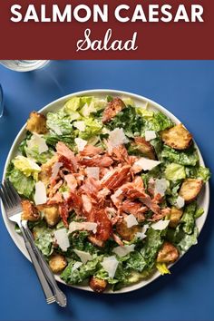 a salad with bacon, lettuce and cheese on it in a white bowl