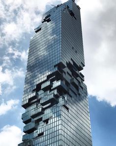 a very tall building with lots of windows on it's side and sky in the background