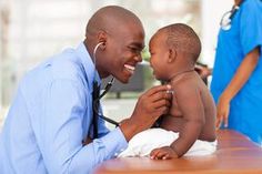 a doctor examining the chest of a small child with his stethoscope on