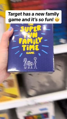 a person holding up a game box with the words super family time on it