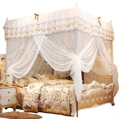 a bed with white drapes on top of it's headboard and foot board