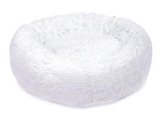 a white dog bed with fluffy fur on the top and bottom, in front of a white background