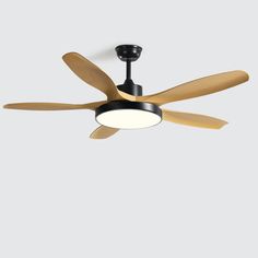 a ceiling fan with three wooden blades and a light on the top, against a gray background