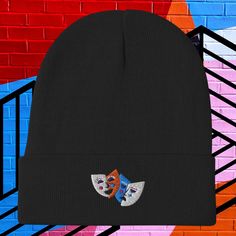 a black beanie with two cats on it