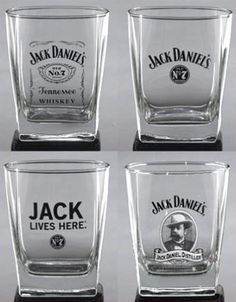 four shot glasses with jack daniels logos on them